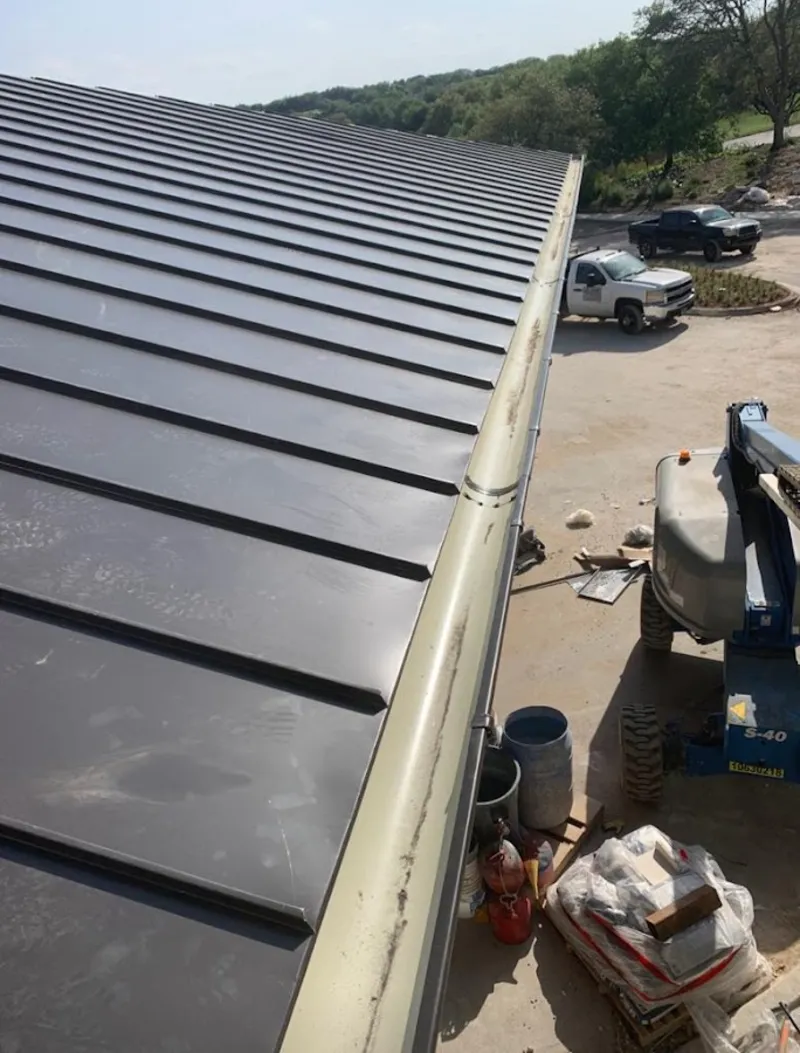 Standing seam panel and gutter detail on a metal roofing jobsite in Riverhead